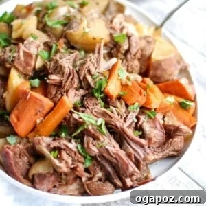 Crockpot Chuck Roast Recipe with potatoes and carrots, ready to serve.