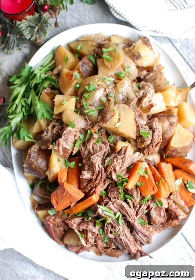 Close-up of Crockpot Chuck Roast garnished with fresh parsley, highlighting its tender texture.