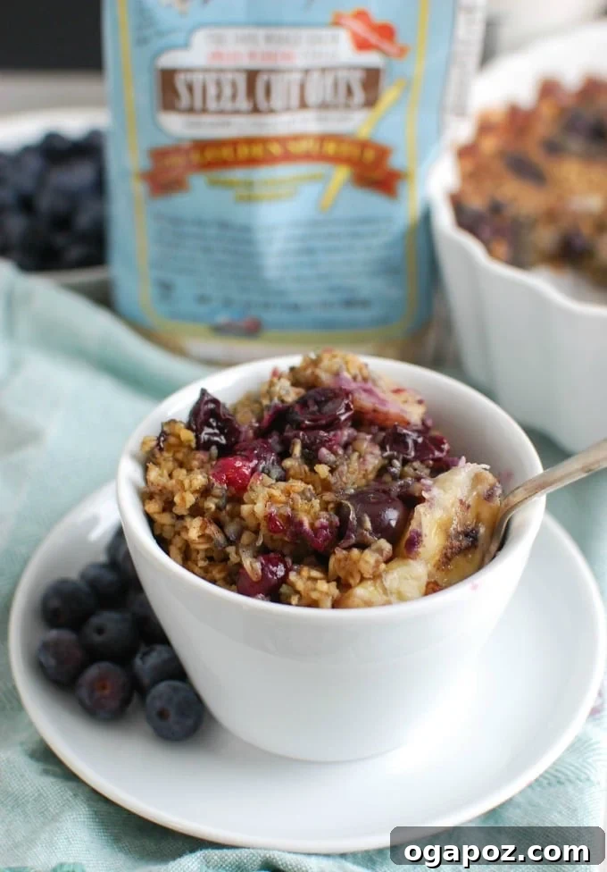 Baked Blueberry Banana Steel Cut Oat Bake 5 A delicious and healthy serving of Baked Blueberry Banana Steel Cut Oatmeal in a bowl, garnished with extra fresh berries, ready to be enjoyed.