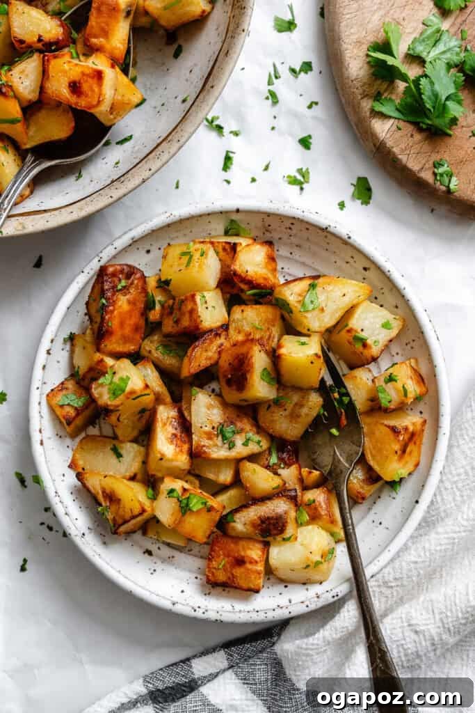 Bright Lemon & Cilantro Roasted Potatoes 9 A bowl of Lemon Cilantro Roasted Potatoes with a serving spoon, ready to eat