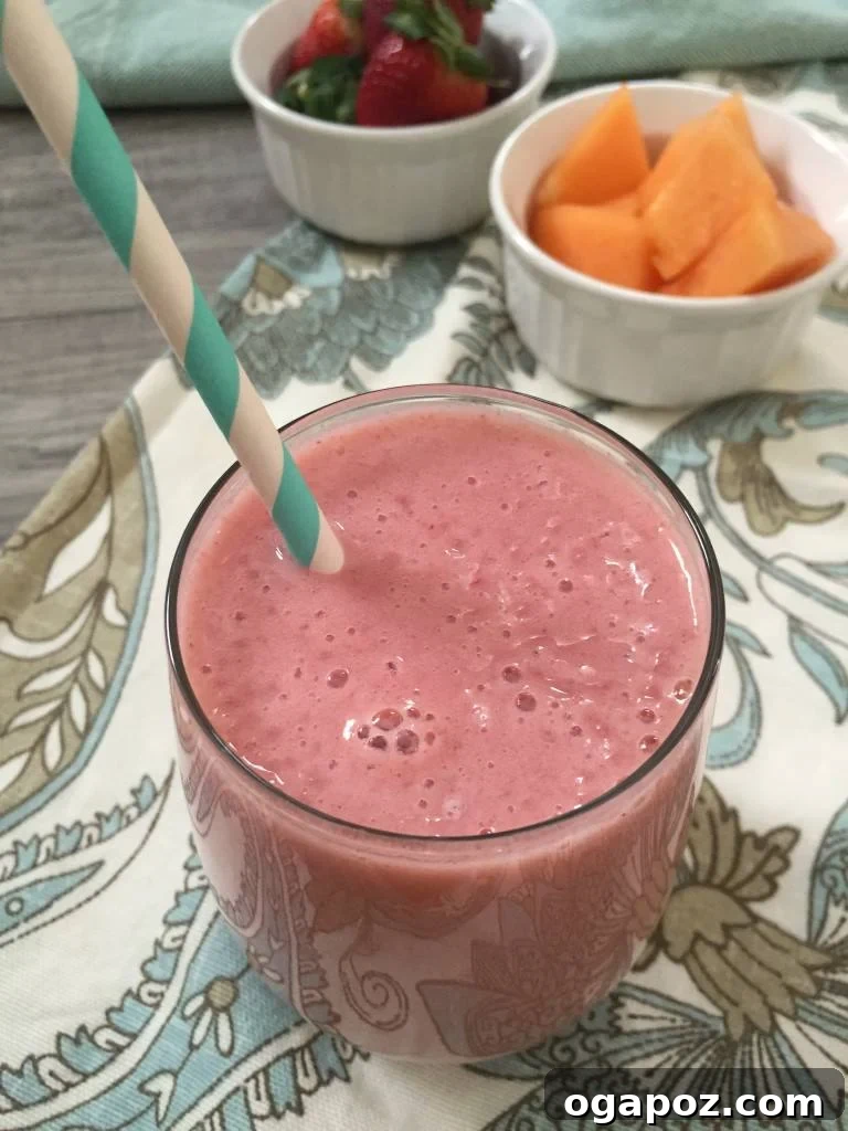 My 2015 Recipe Vault: The 15 Most Delicious Dishes 6 A vibrant and refreshing Strawberry Cantaloupe Smoothie, showcasing a beautiful orange-pink color, served in a glass with a straw
