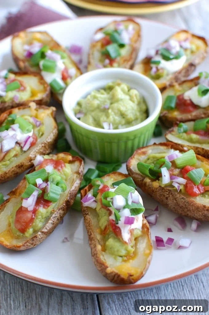 Guacamole Loaded Potato Skins 3 Guacamole Stuffed Potato Skins on white plate