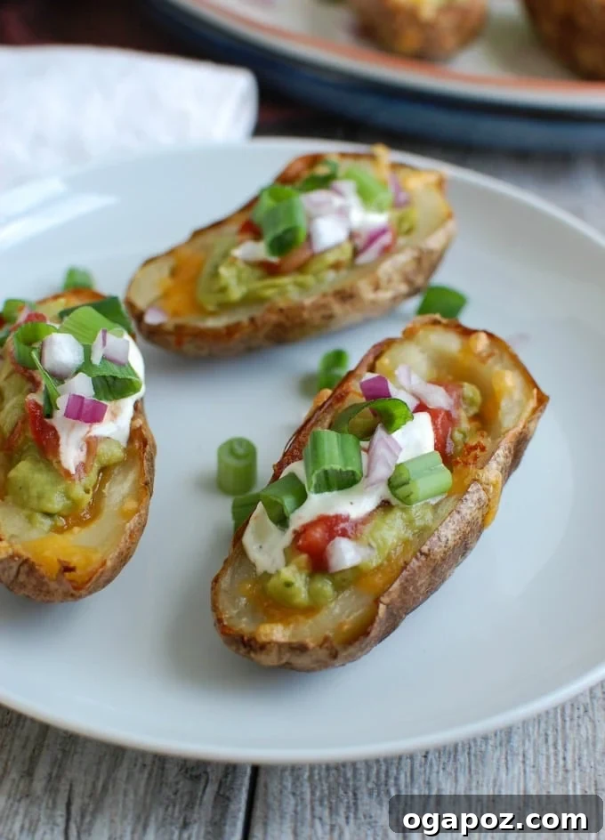 Guacamole Loaded Potato Skins 5 Guacamole Stuffed Potato Skins on a plate