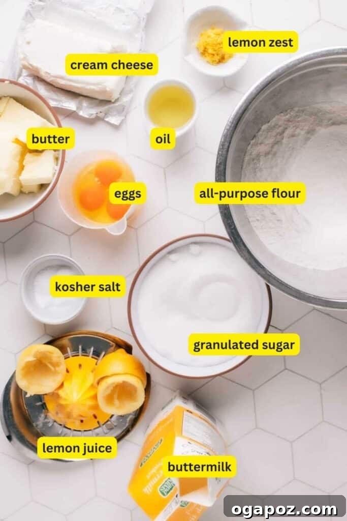Zesty Lemon Curd Delight 5 All ingredients for baking a Lemon Curd Cake are neatly arranged on a kitchen counter, including flour, eggs, cream cheese, fresh lemons, butter, oil, sugar, and buttermilk.