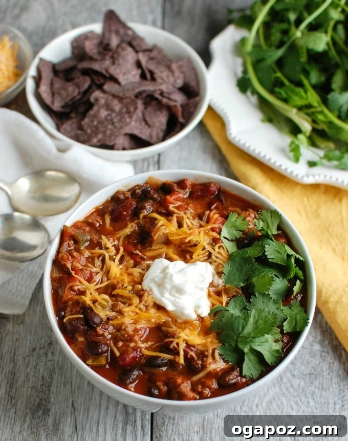 Close-up of Beef and Bean Chili with sour cream and a spoon