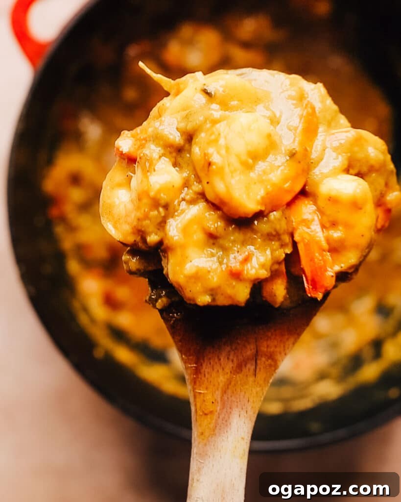 Flavorful Jamaican Curry Shrimp 7 A spoonful of Jamaican Curry Shrimp showing the tender shrimp and rich, spicy coconut sauce.