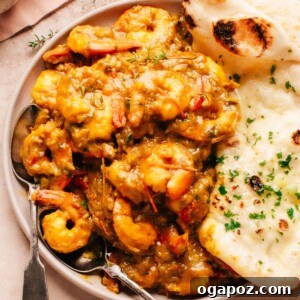 Jamaican Curry Shrimp on a plate with naan bread.