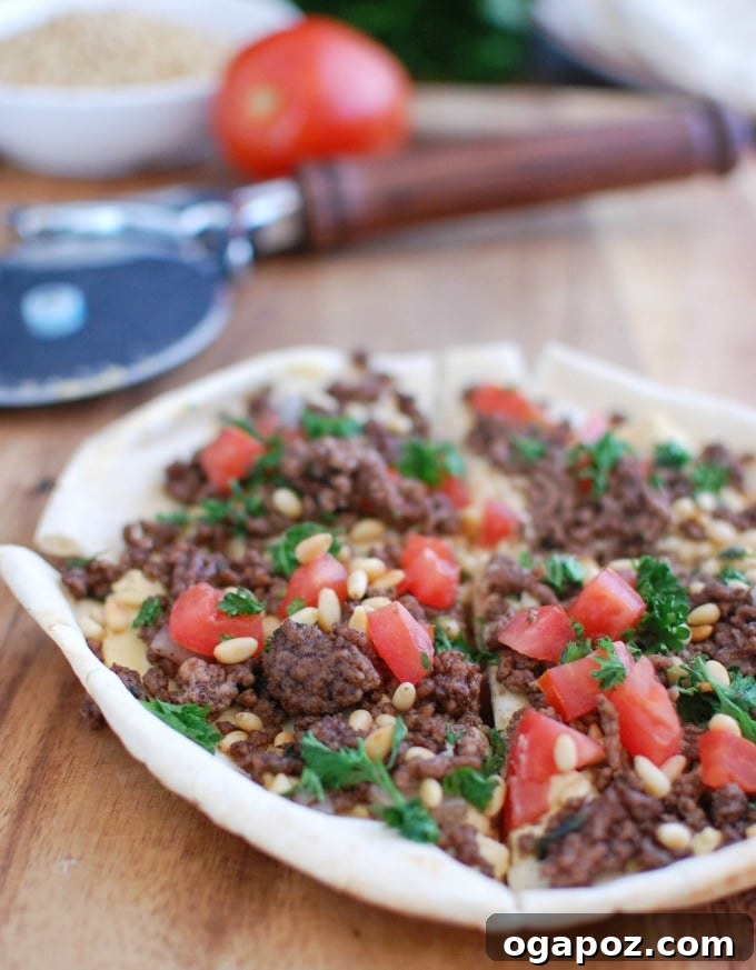 Spiced Beef and Hummus Pita Pizza on cutting board, ready to serve.