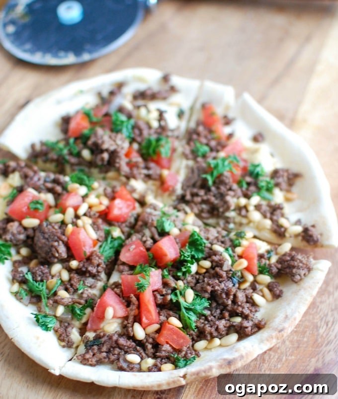 Overhead shot of Spiced Beef and Hummus Pita Pizza before baking.