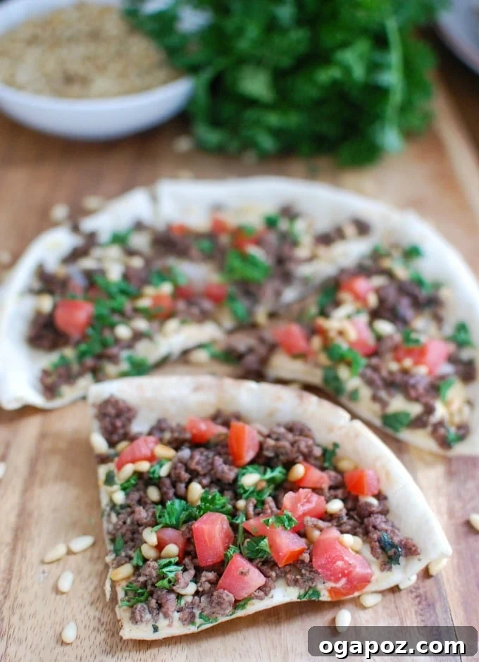 Spiced Beef and Hummus Pita Pizza with a pizza slicer, ready for serving.