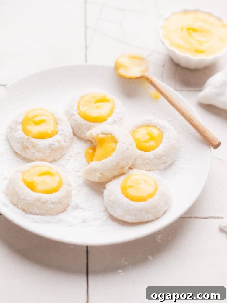 Sun-Kissed Lemon Curd Treats 2 A plate piled high with golden-baked Lemon Curd Cookies, each filled with a glistening dollop of creamy lemon curd.