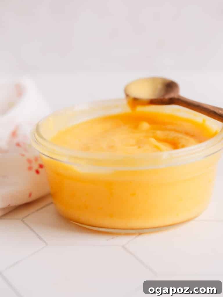 Sun-Kissed Lemon Curd Treats 4 A bowl of homemade lemon curd, glistening and smooth, ready to fill the delicate shortbread cookies.