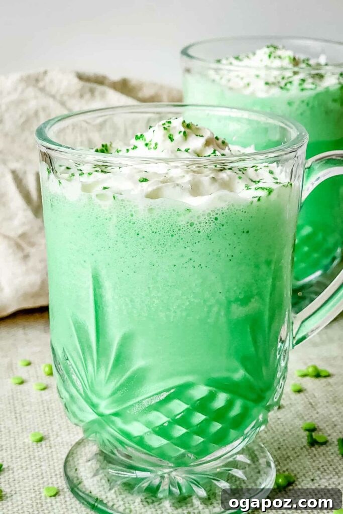 Luck of the Irish: Delicious Green Desserts for St Patricks Day 13 A glass of copycat Shamrock Shake with bright green hue and whipped cream on top, a refreshing mint-flavored beverage for St. Patrick's Day.