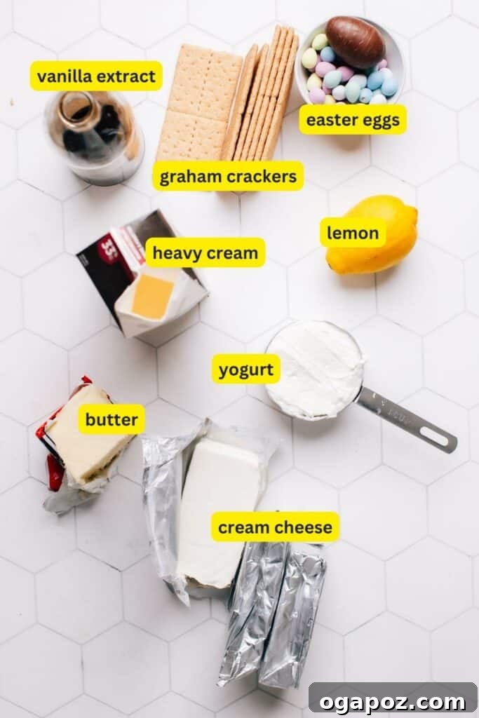 Colorful Easter Egg Cheesecake Chill 4 An array of ingredients for an Easter Egg Cheesecake displayed on a kitchen counter, including bricks of cream cheese, heavy cream, vanilla extract, a bowl of graham cracker crumbs, butter, fresh lemons, yogurt, and a variety of colorful Easter eggs.