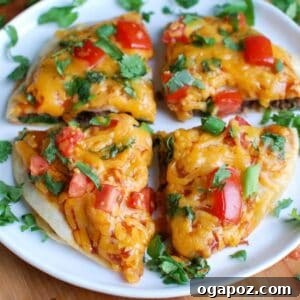 A single serving of Mexican Pizza with a crispy crust and melted cheese, ready to be eaten.