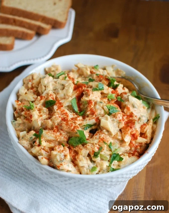 Homestyle Sweet Southern Egg Salad 2 A beautifully presented bowl of Sweet Southern-Style Egg Salad, garnished with fresh herbs and spices, ready to be served.