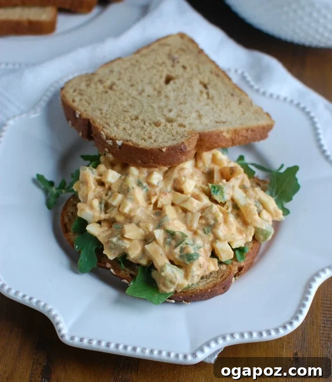 Homestyle Sweet Southern Egg Salad 4 Sweet Southern-Style Egg Salad served as a sandwich on toasted bread, garnished with fresh parsley.