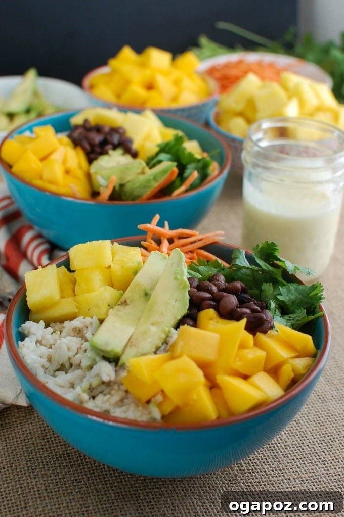 Tropical Coconut Rice Bliss 4 Overhead shot of a Tropical Coconut Rice Bowl with a small pitcher of creamy pineapple dressing beside it, ready to be drizzled.