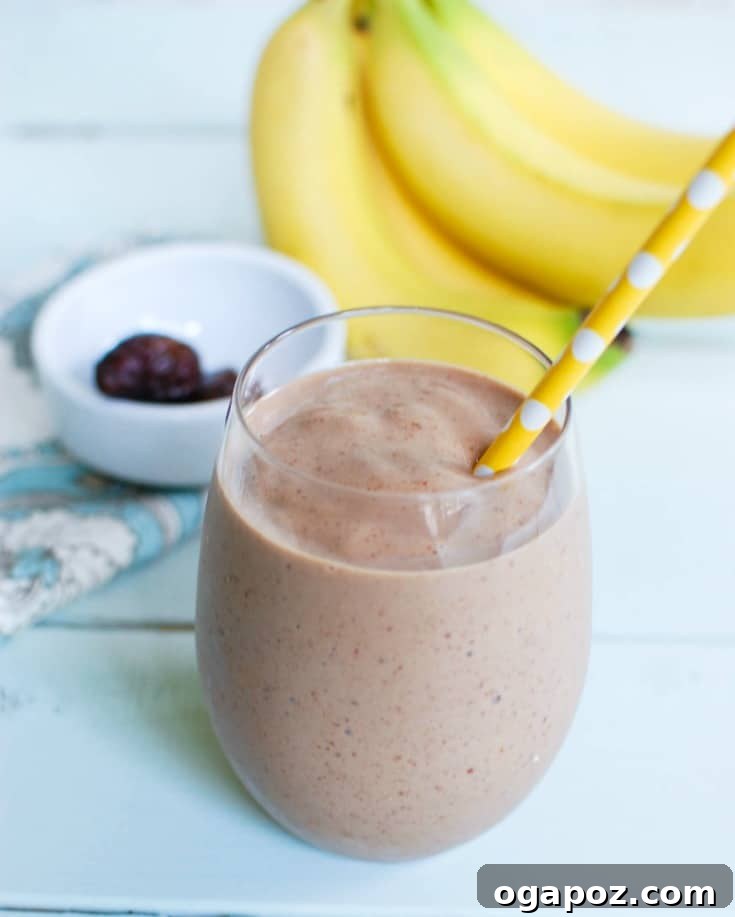 Golden Banana Date Delight 4 Banana Date Smoothie with a straw, ready to be enjoyed. A healthy and delicious way to start the day or refresh in the afternoon.