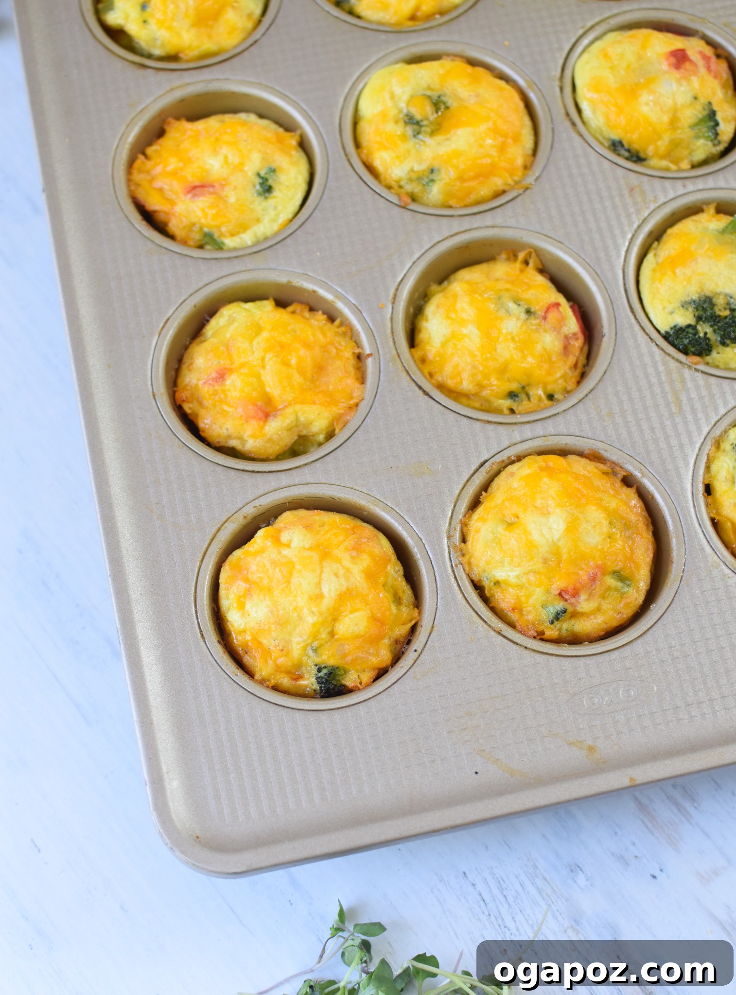 Cheesy Broccoli Bites 8 Freshly baked Broccoli Cheddar Cups cooling gently in a muffin tin, ready to be enjoyed or stored for later.