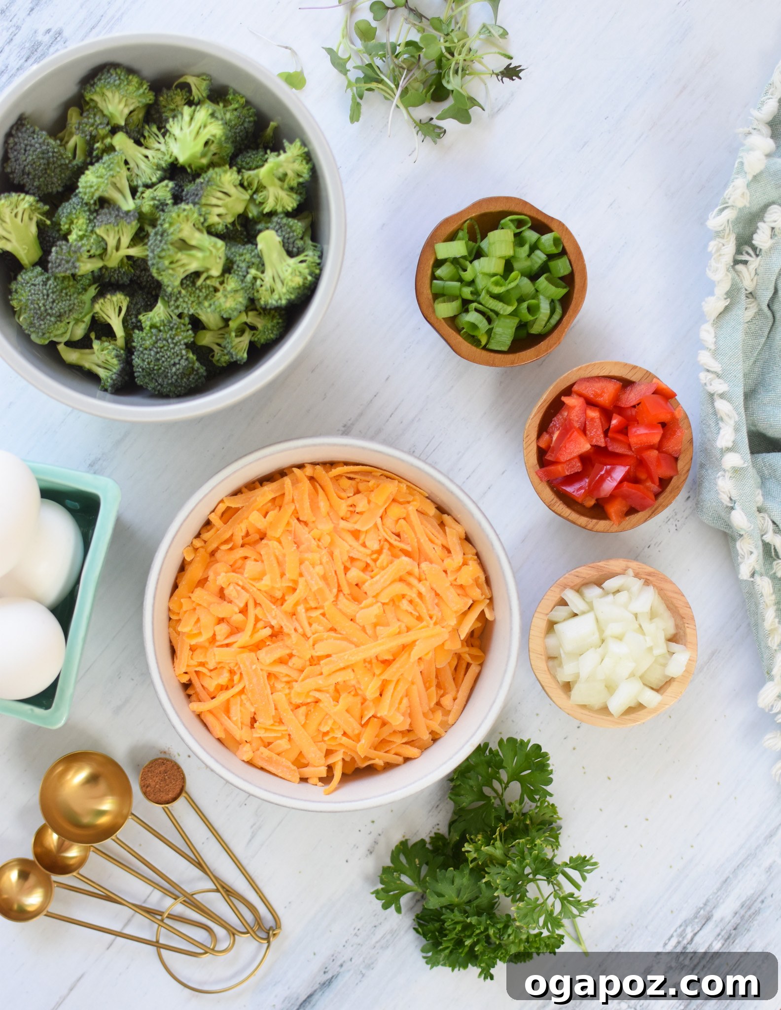 Cheesy Broccoli Bites 5 A vibrant display of fresh ingredients for Broccoli Cheddar Cups, including raw broccoli florets, bell peppers, onions, and cheddar cheese.