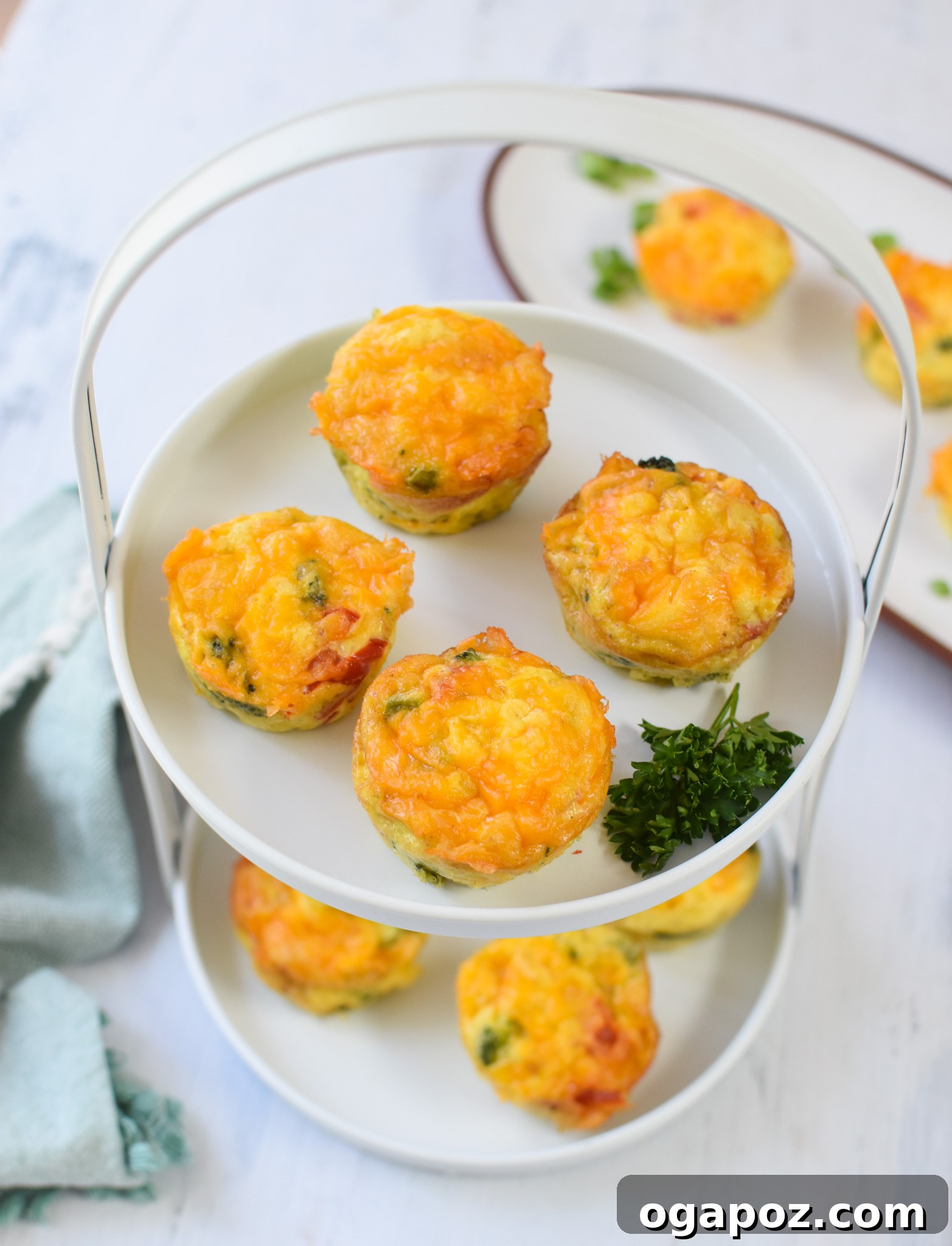 Cheesy Broccoli Bites 6 A perfectly baked Broccoli Cheddar Cup, golden brown and fluffy, presented on a simple white plate.