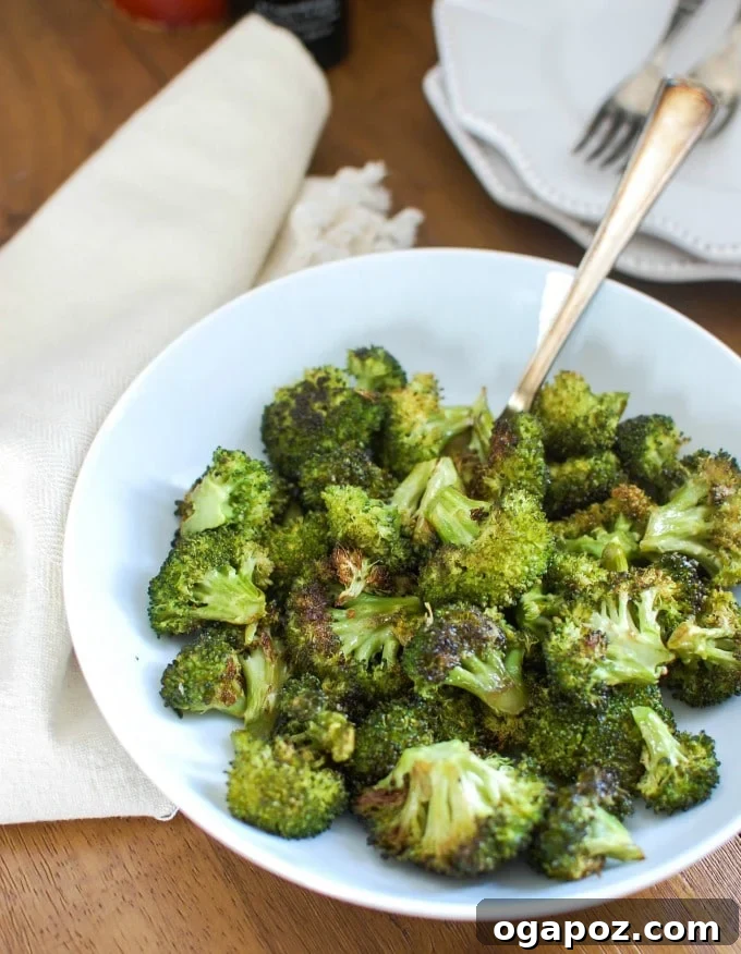 Golden Roasted Broccoli 2 Roasted Broccoli in a bowl with a spoon, perfectly golden and tender-crisp.