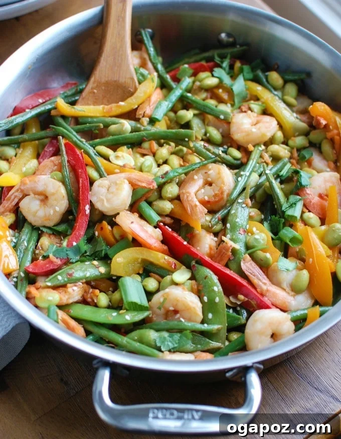 Fresh Wok-Tossed Shrimp & Edamame 3 Close-up of Asian Shrimp Edamame Stir-Fry in a skillet, showcasing the cooking process and vibrant ingredients.