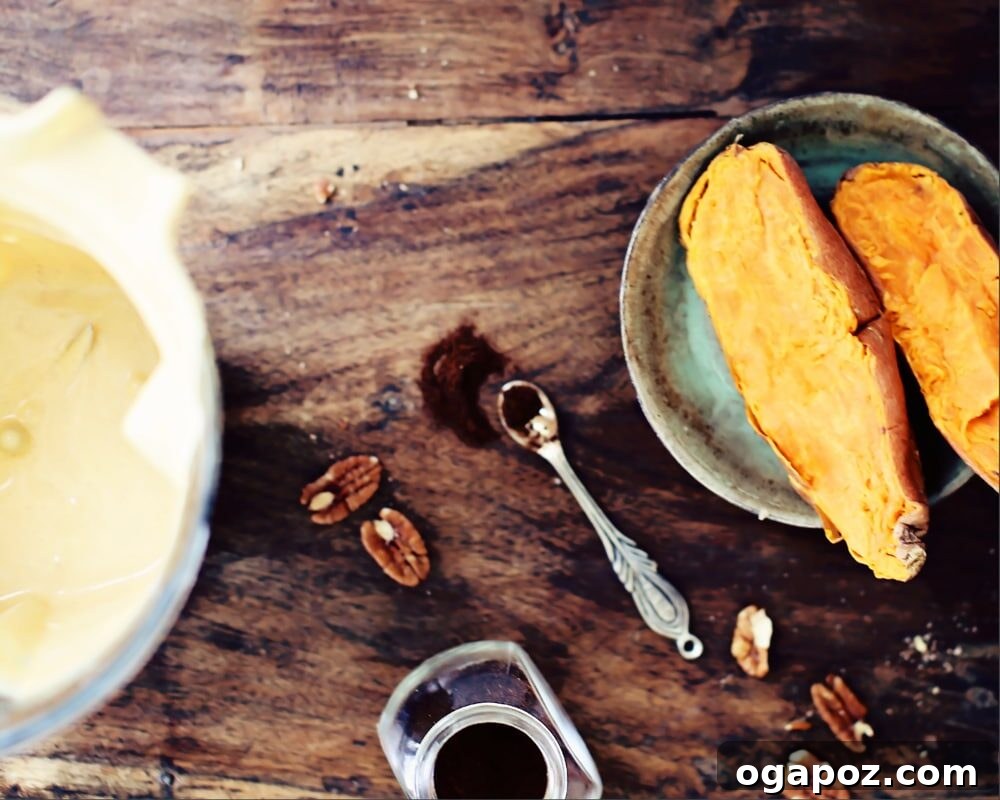 Decadent Sweet Potato Pecan Cheesecake 3 Various ingredients for sweet potato cheesecake laid out, including pecans, oats, cream cheese, and spices.