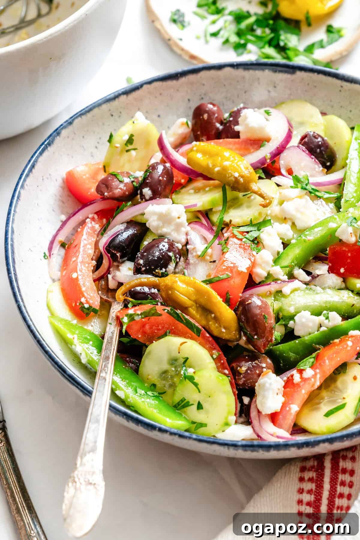 Rustic Greek Garden Salad 2 Fresh Greek Village Salad in a white bowl with a fork, ready to be served.