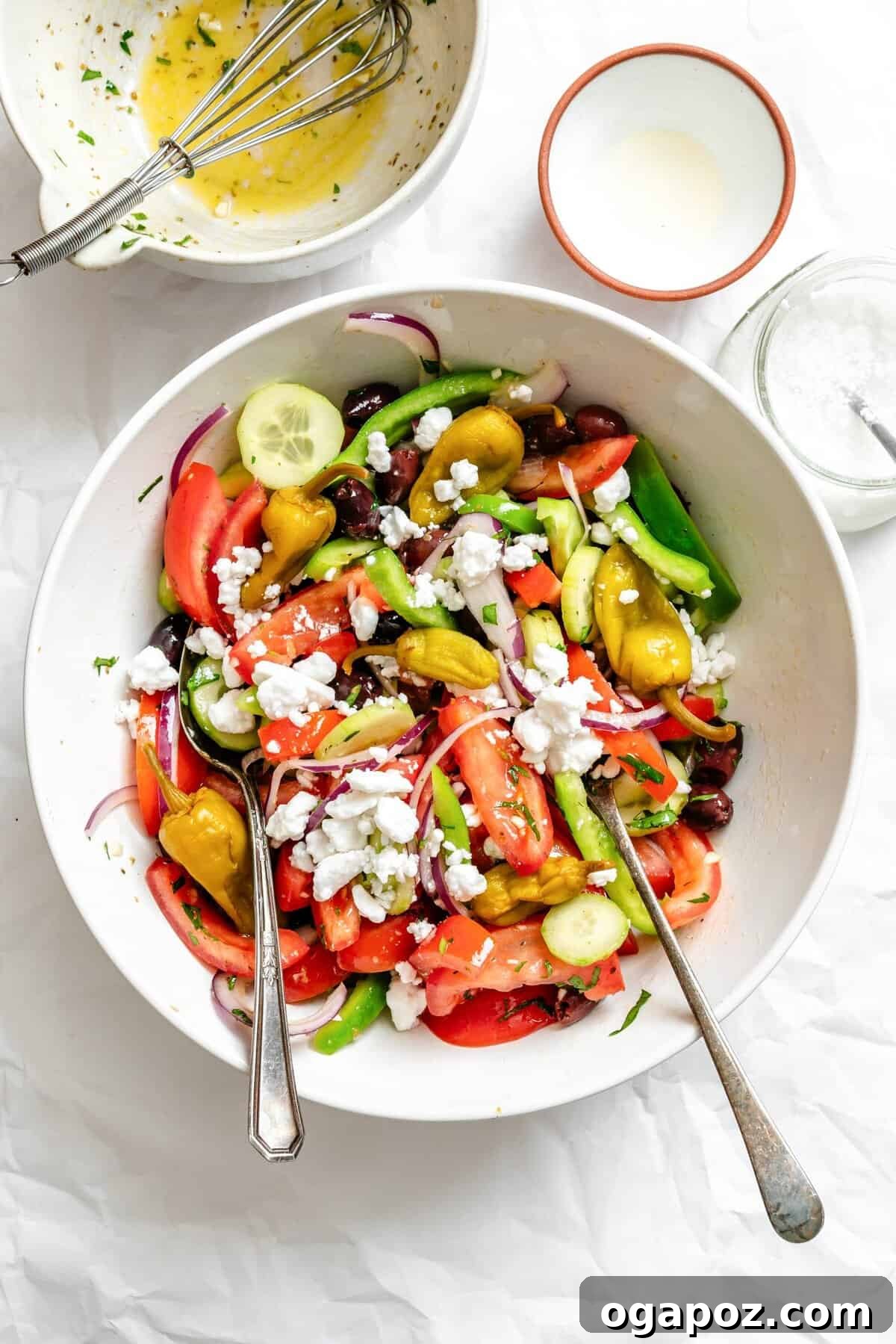 Rustic Greek Garden Salad 11 A large bowl of Greek Village Salad with serving spoons, perfect for sharing.