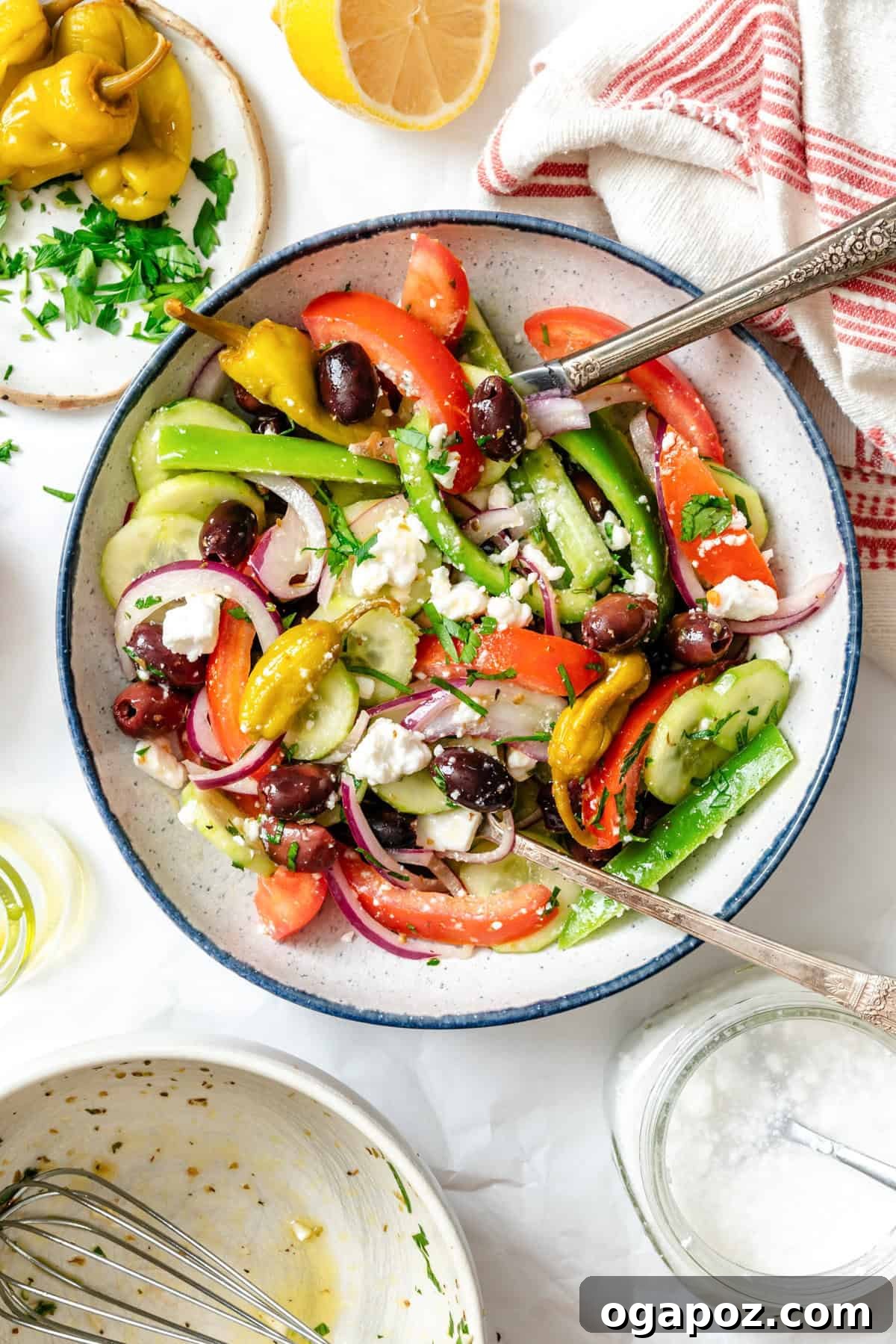 Rustic Greek Garden Salad 5 A bowl of Greek Village Salad with a blue rim, served with a fork.