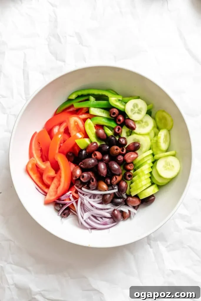 Rustic Greek Garden Salad 9 Assorted fresh vegetables for Greek Village Salad in a large mixing bowl.