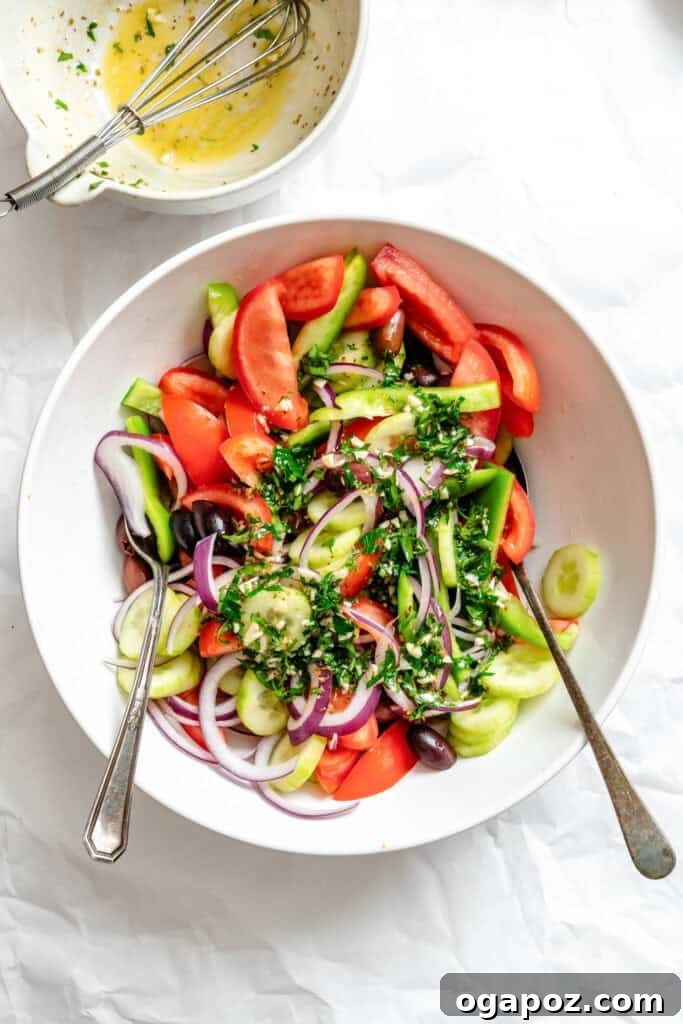 Rustic Greek Garden Salad 10 Greek Village Salad vegetables in a bowl with herbs, ready for dressing.
