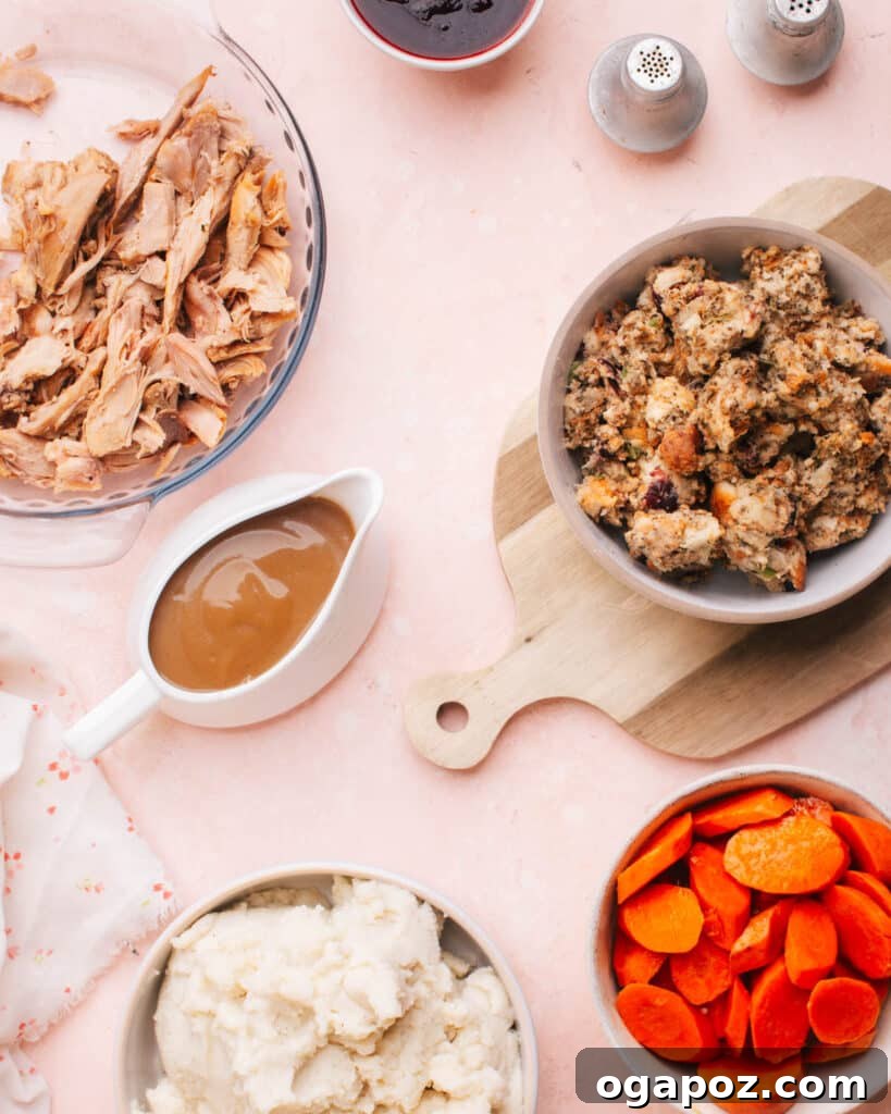 Apple and Turkey Stuffing Bake 4 A festive Thanksgiving table featuring roasted turkey, creamy mashed potatoes, savory apple herb stuffing, glazed carrots, and rich giblet gravy without drippings.