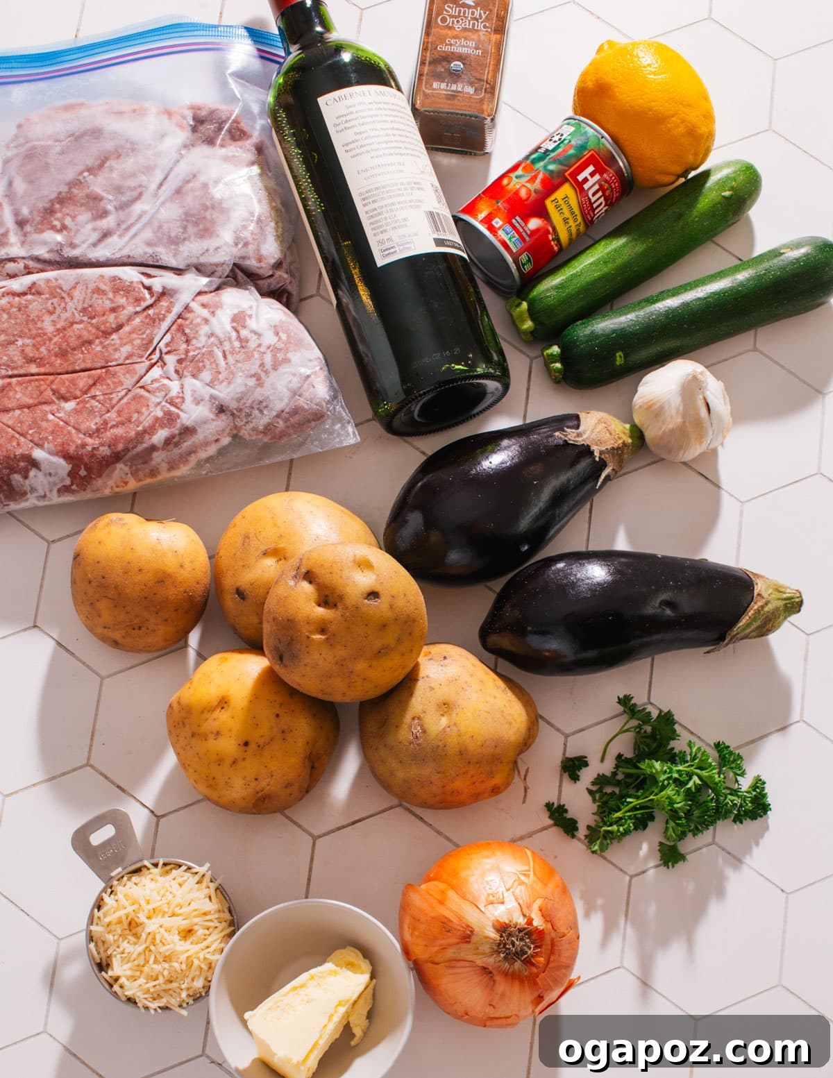 Greek Lamb and Potato Pie 3 Ingredients for Greek Shepherd's Pie laid out, featuring ground lamb, vegetables, and potatoes.