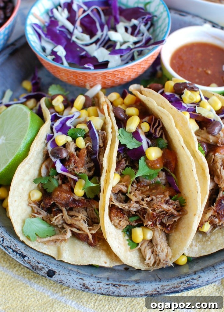 Effortless Slow Cooker Pork Carnitas 2 Delicious Easy Slow Cooker Pork Carnitas Tacos, garnished with fresh cilantro and lime