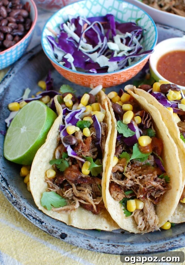 Effortless Slow Cooker Pork Carnitas 4 Two vibrant Slow Cooker Pork Carnitas tacos, garnished with fresh toppings