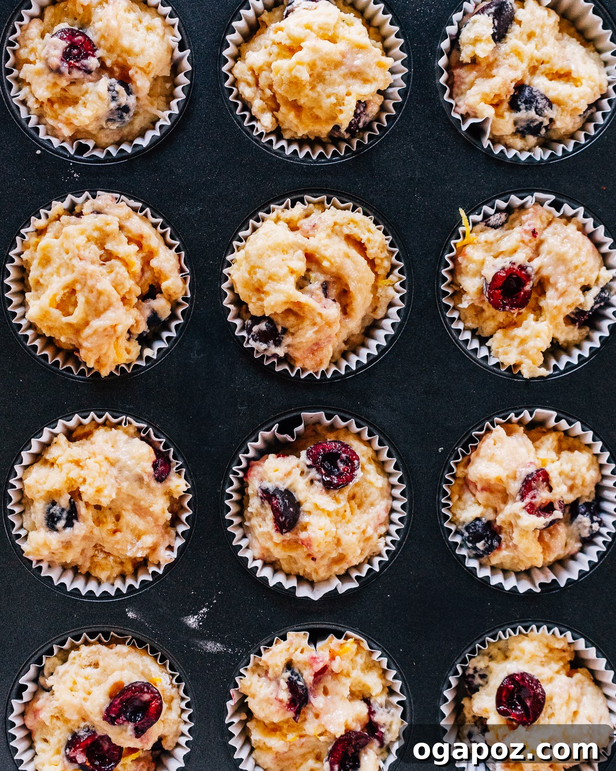 Bursting Cherry Muffins 7 Muffin batter filled into a muffin tin, ready for baking.
