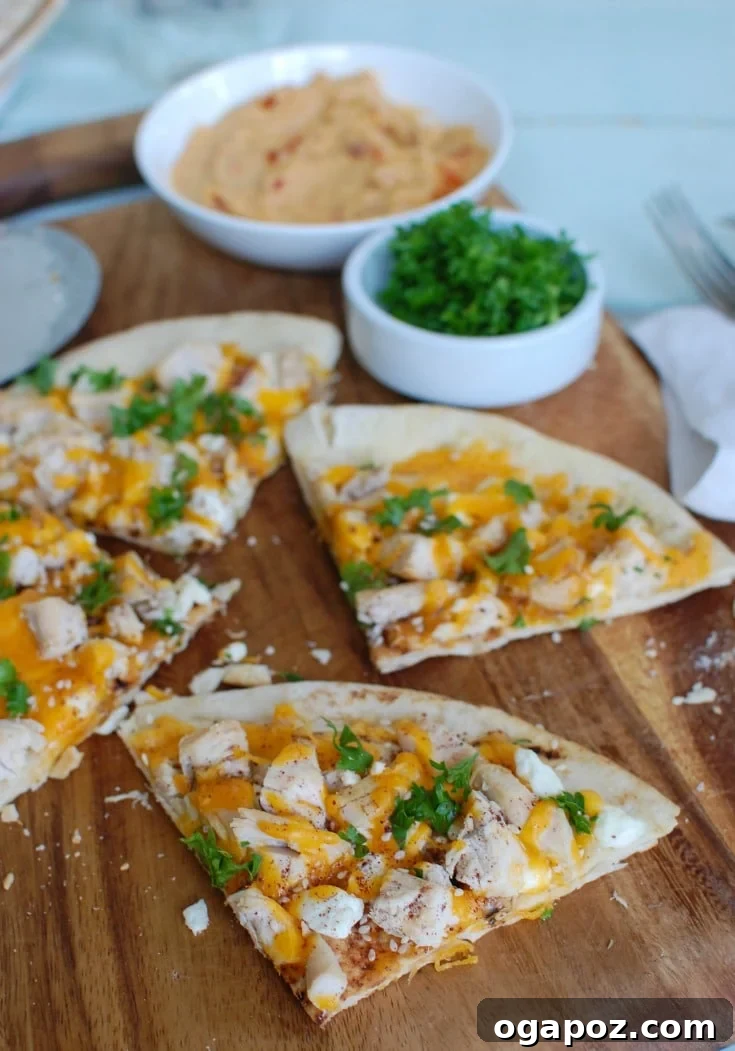 Savory Chicken Feta Cheddar Pita Pizza 3 Close-up of Chicken Feta Cheddar Pita Pizza garnished with fresh parsley and a sprinkle of Za'atar.