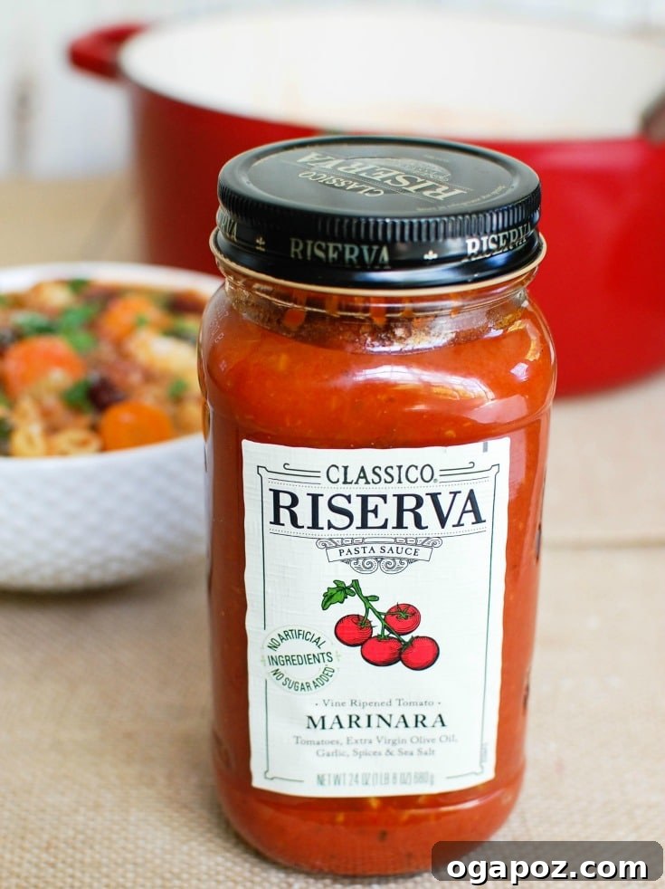Heartwarming Homemade Minestrone 5 Homemade Minestrone Soup with a jar of marinara sauce clearly visible, highlighting a key ingredient.