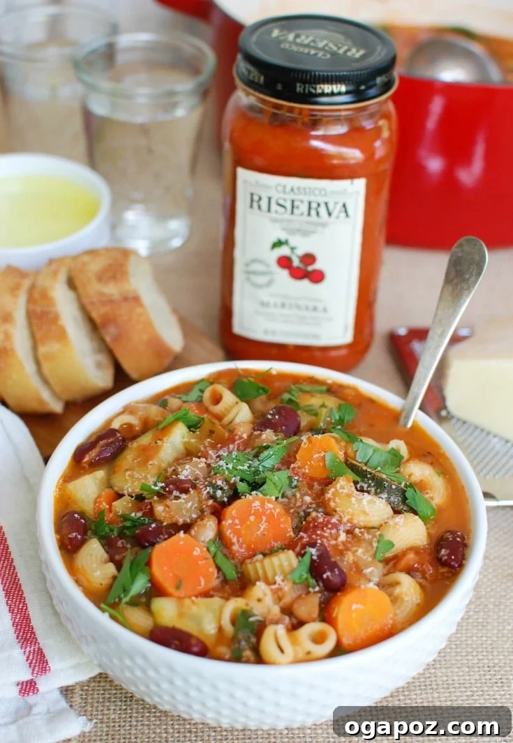 Heartwarming Homemade Minestrone 6 Homemade Minestrone Soup Recipe with a spoon dipped into the hearty vegetable and bean-filled broth.