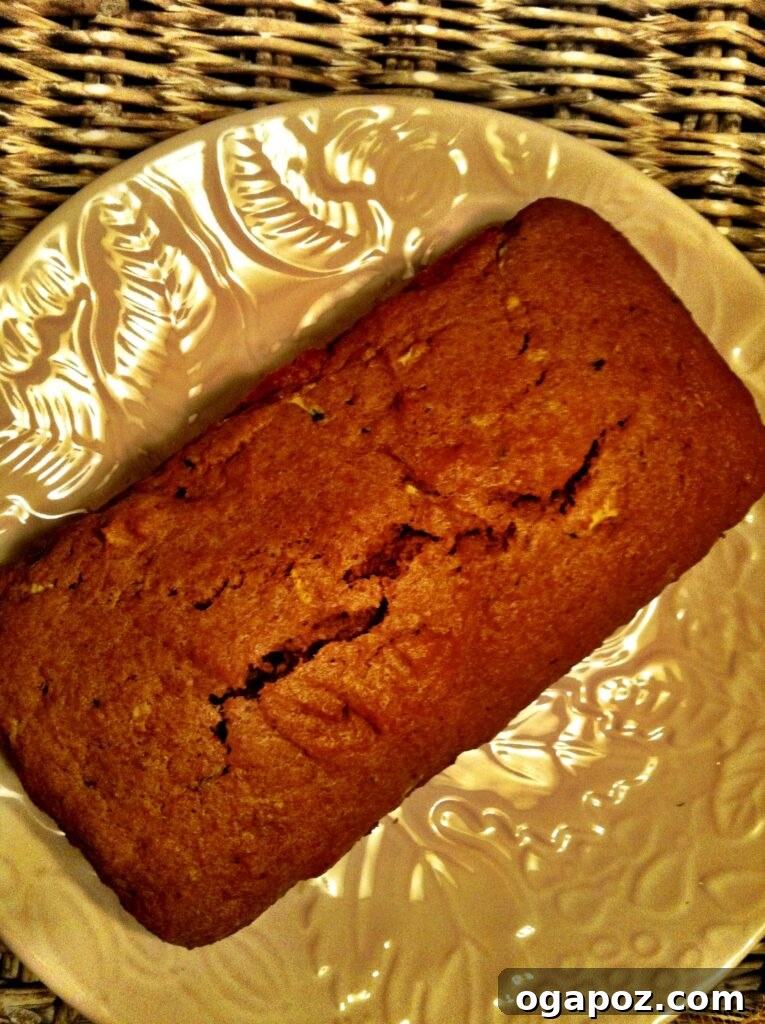 Freshly baked Pumpkin Zucchini Bread loaf on a cooling rack