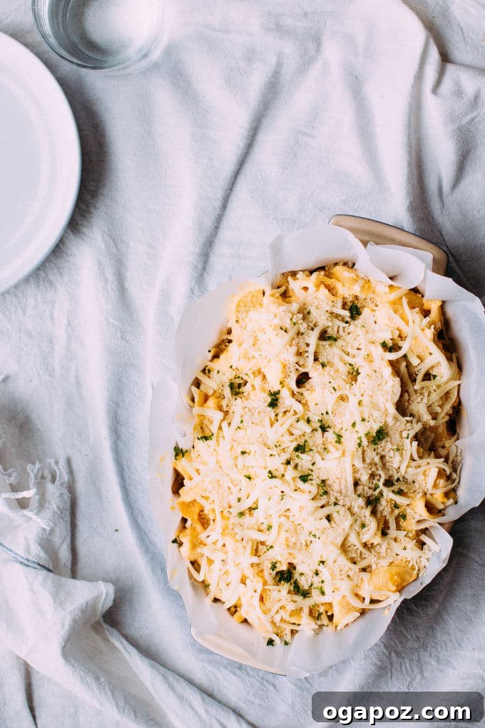 Umami Carrot Mac 3 A bowl of Miso Carrot Mac and Cheese, garnished with fresh herbs, ready to be enjoyed, highlighting its rich, cheesy texture.