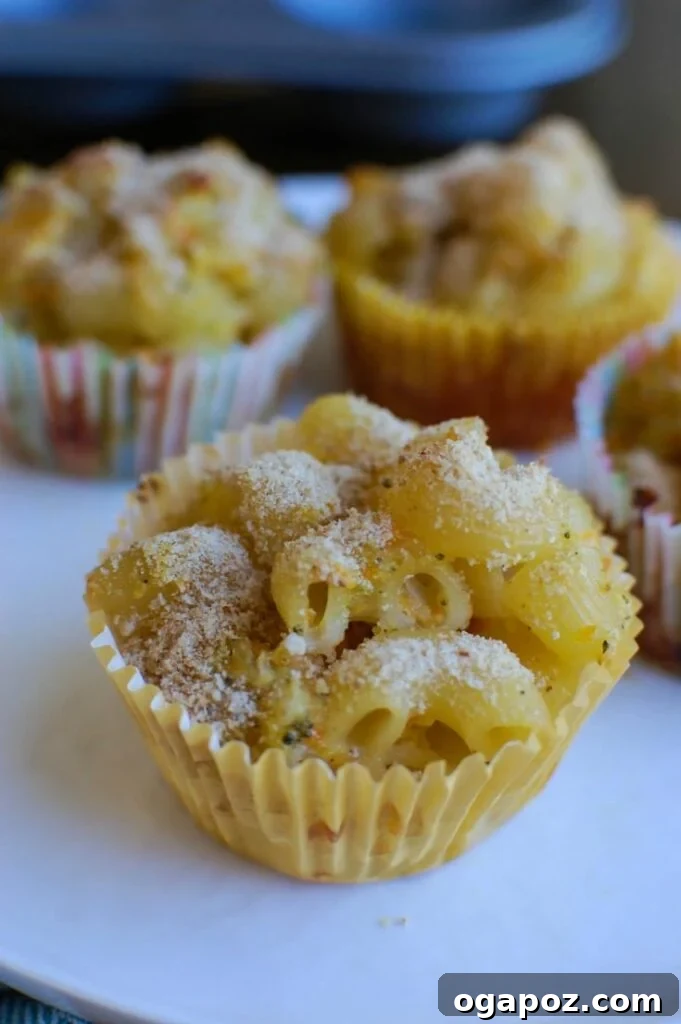 Cheesy Mac Bites 5 A close-up shot of several Mac and Cheese Muffins, perfectly golden and ready to eat.
