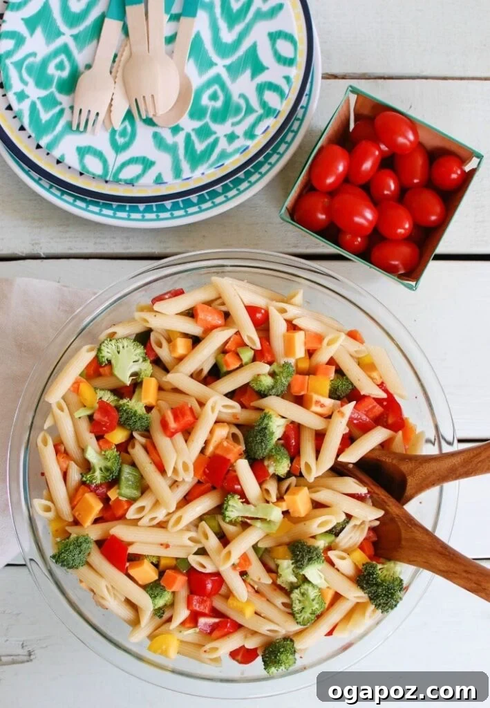 The Ultimate Pasta Salad 3 A close-up of Classic Pasta Salad, showcasing its vibrant array of fresh vegetables and delectable texture, perfect for a summer BBQ.