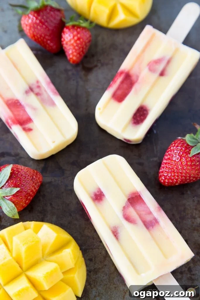 25 Ice Pop Sensations to Conquer Summer Heat 24 Vibrant Mango Strawberry Vanilla Yogurt Popsicles, a creamy and fruity healthy dessert.
