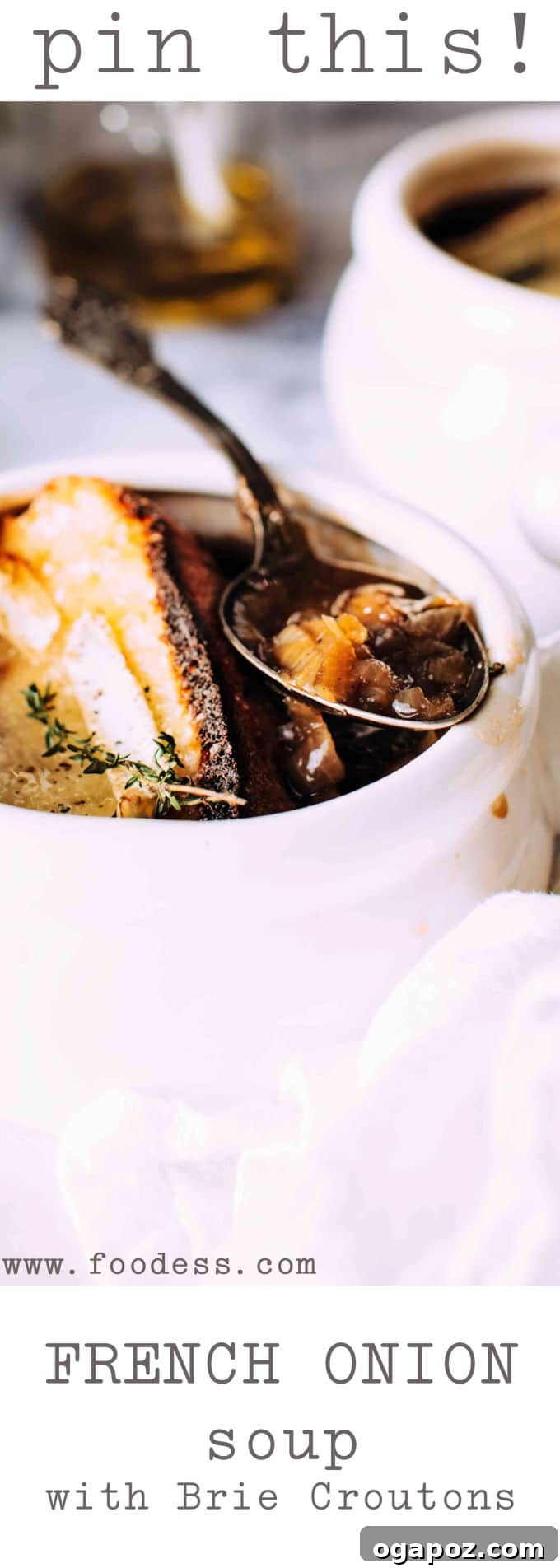 French Onion Soup with Golden Brie Crowns 5 Four bowls of French Onion Soup with giant brie croutons, garnished with fresh thyme, presented on a wooden board.