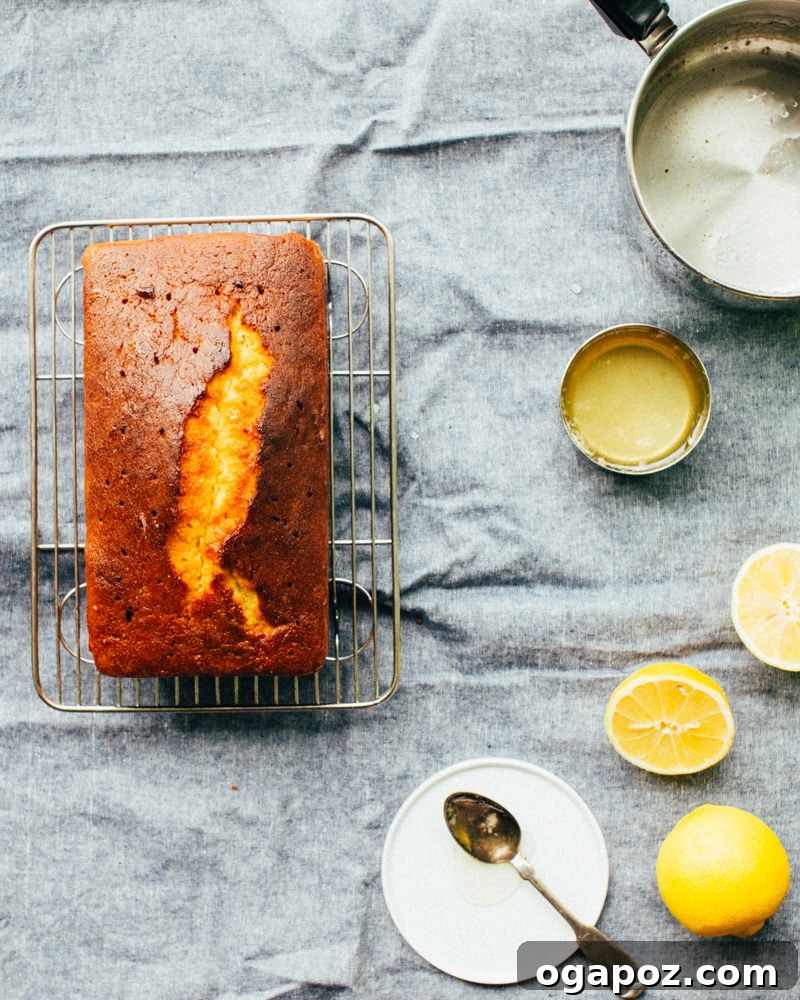 Sunshine Lemon Loaf 3 Close-up of a slice of Lemon Pound Cake revealing its moist, tender crumb and the thick, glistening lemon glaze.