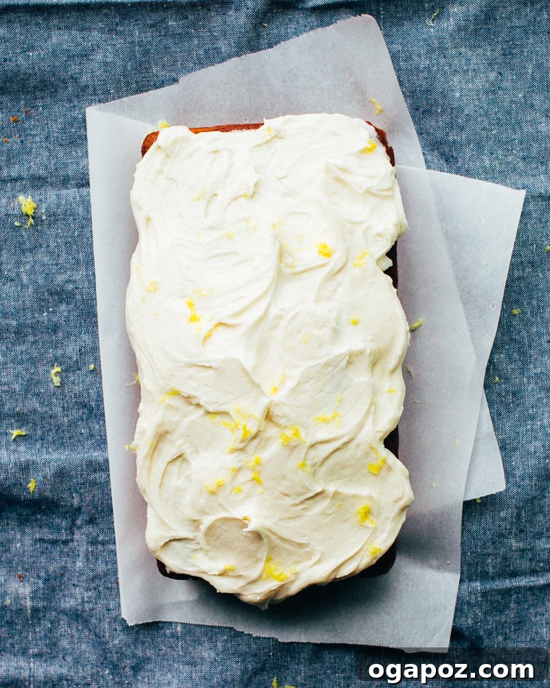 Sunshine Lemon Loaf 5 A freshly baked Lemon Pound Cake, sliced and ready to serve, garnished with lemon zest and fresh berries.